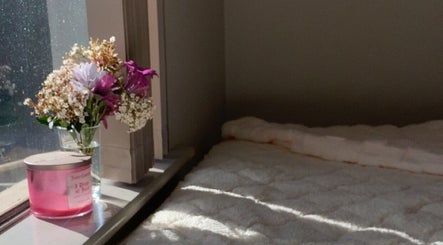 Warm sunlight on cozy bed with flowers at Dolled Up By Lily, Kelmscott, Western Australia, AU.