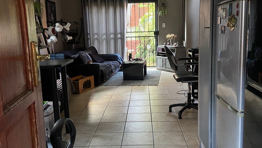 Cutz Hair Crew salon seating area with soft lighting in Randburg, Gauteng, ZA, offering a welcoming ambiance.