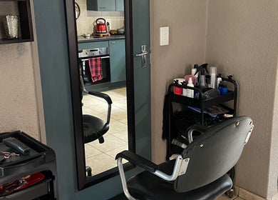 Hair styling station at Cutz Hair Crew, Randburg, Gauteng, ZA featuring a mirror and salon chair.