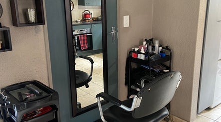 Hair styling station at Cutz Hair Crew, Randburg, Gauteng, ZA featuring a mirror and salon chair.