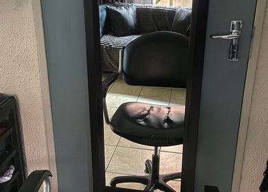 Modern salon chair and mirror at Cutz Hair Crew, Randburg, Gauteng, ZA, showcasing a stylish workspace.