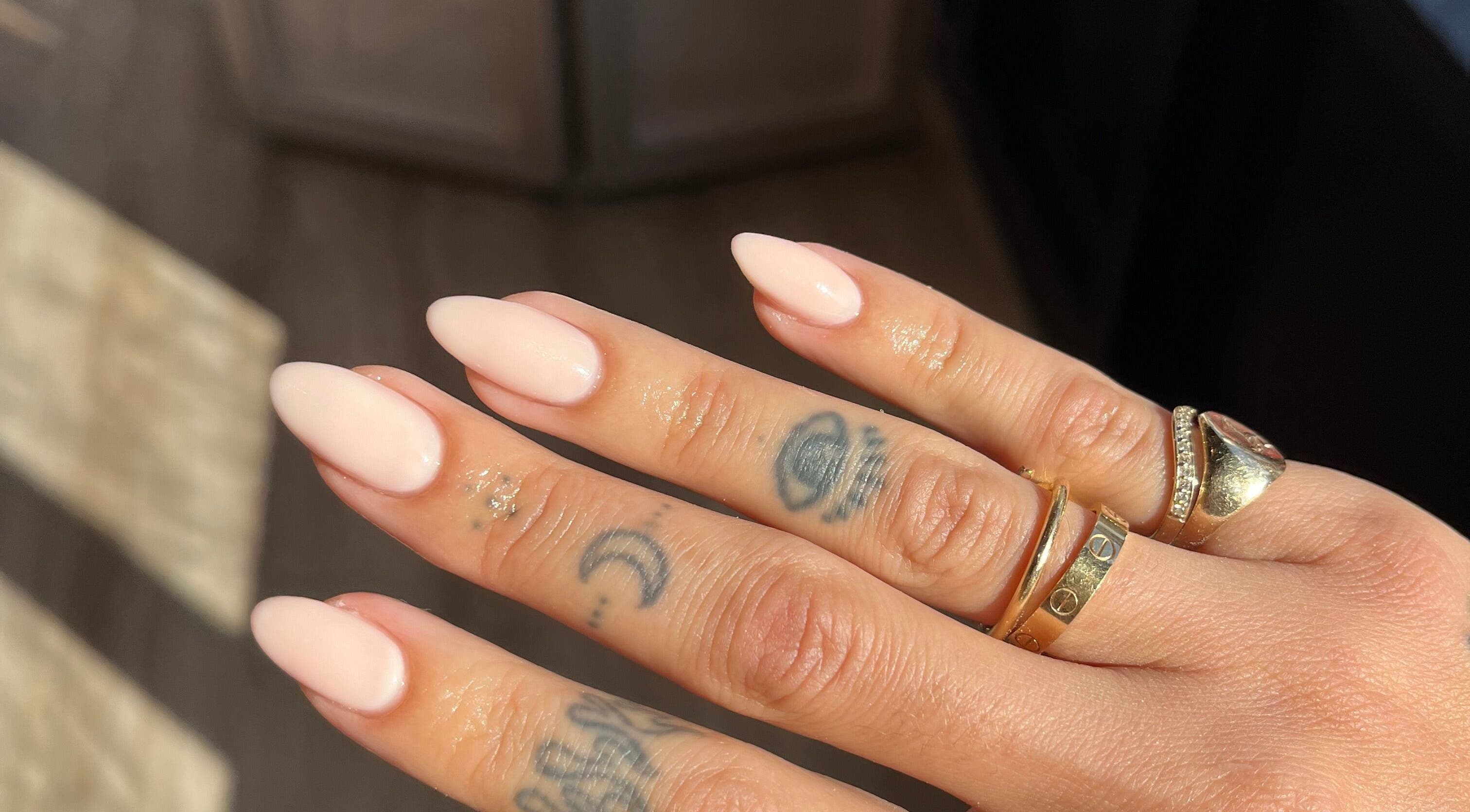 Elegant manicured nails with rings at The Secret Beauty Bar LDN, London, England, GB.