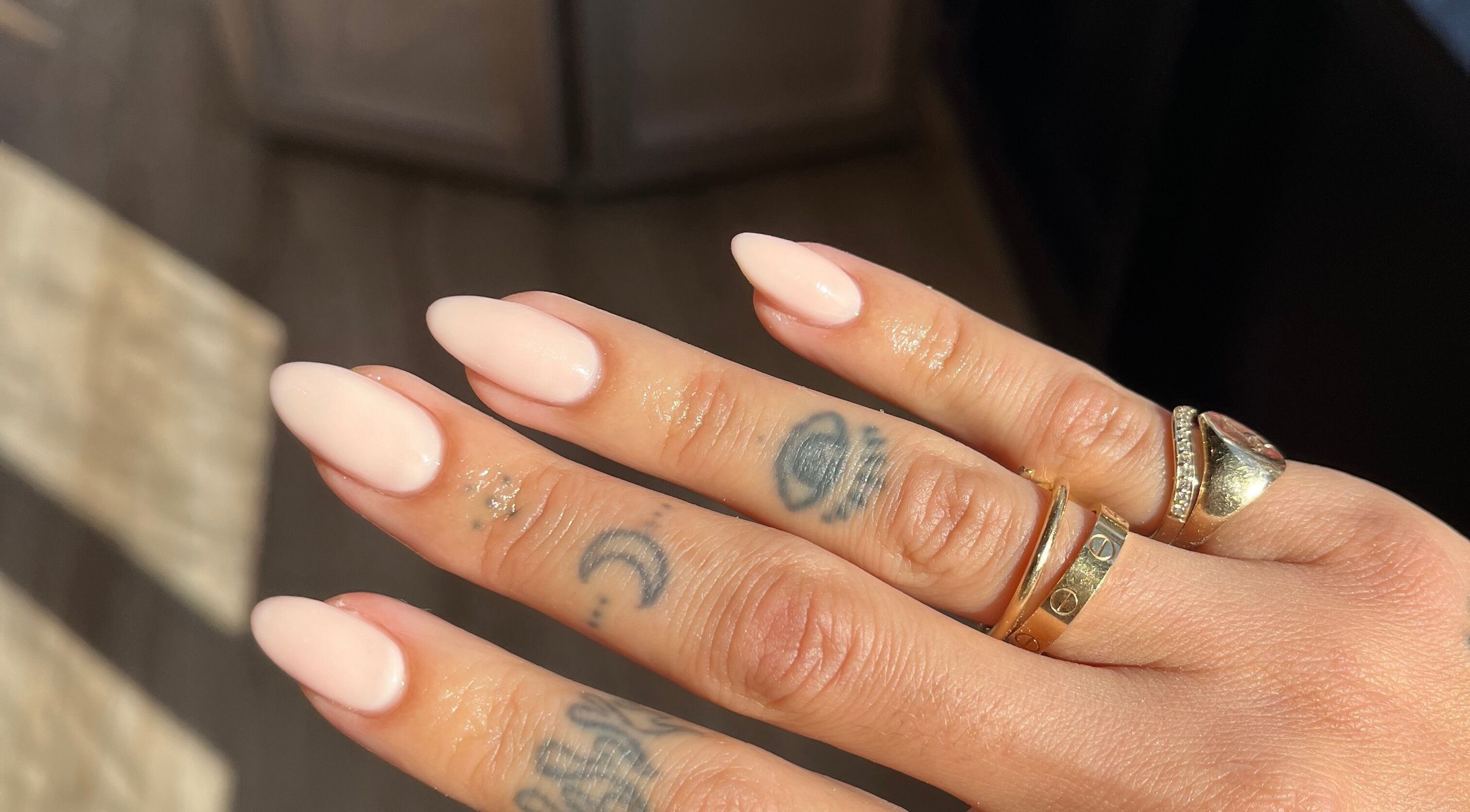 Elegant manicured nails with rings at The Secret Beauty Bar LDN, London, England, GB.