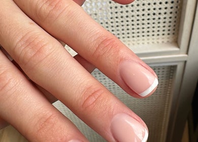 Elegant French manicure at The Secret Beauty Bar LDN in London, England, GB, showcasing perfect nail care.