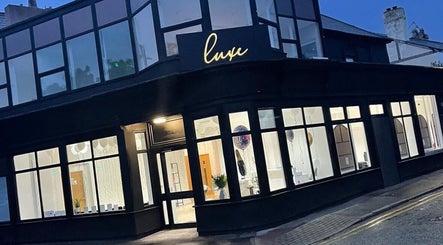 Renū wellness venue exterior at evening, West Kirby, England, GB with elegant lighting and modern design.