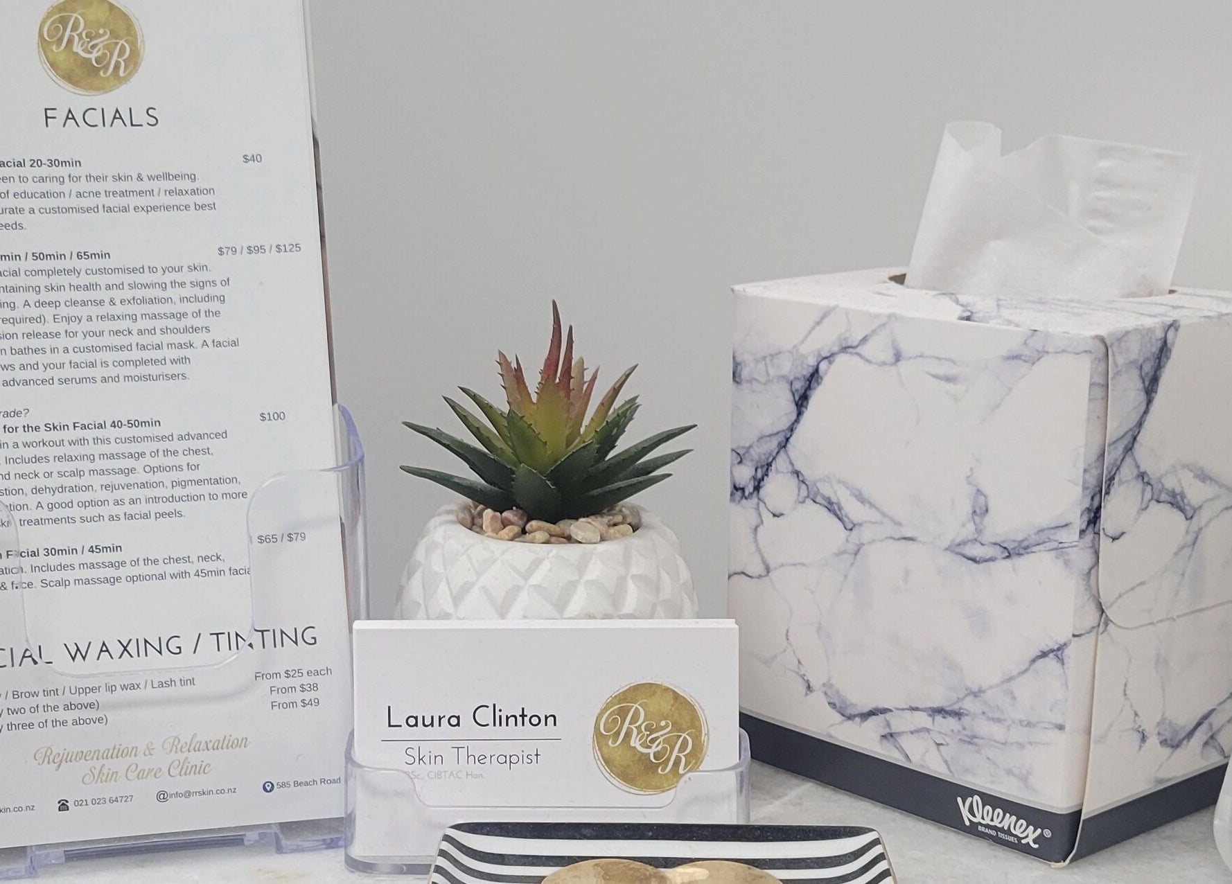 R&R Skin Care Clinic brochure, card, and decor at Auckland, NZ, showcasing facial services and relaxation ambiance.