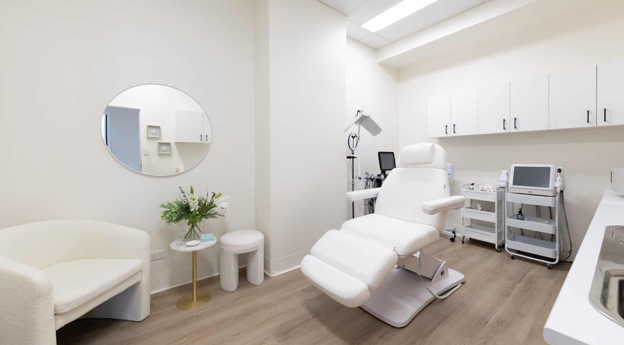 Luxurious treatment room at Lumina Skincare Clinic, Gold Coast, Queensland, AU. Elegant white decor.