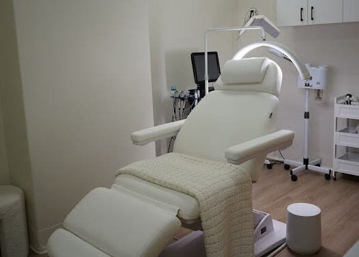 Luxurious treatment room at Lumina Skincare Clinic, Gold Coast, Queensland, AU, featuring a modern recliner.