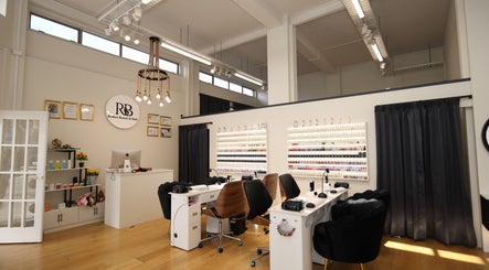 Interior of Reshu's Beauty & Nails PONSONBY in Auckland, NZ, showcasing elegant nail service stations.