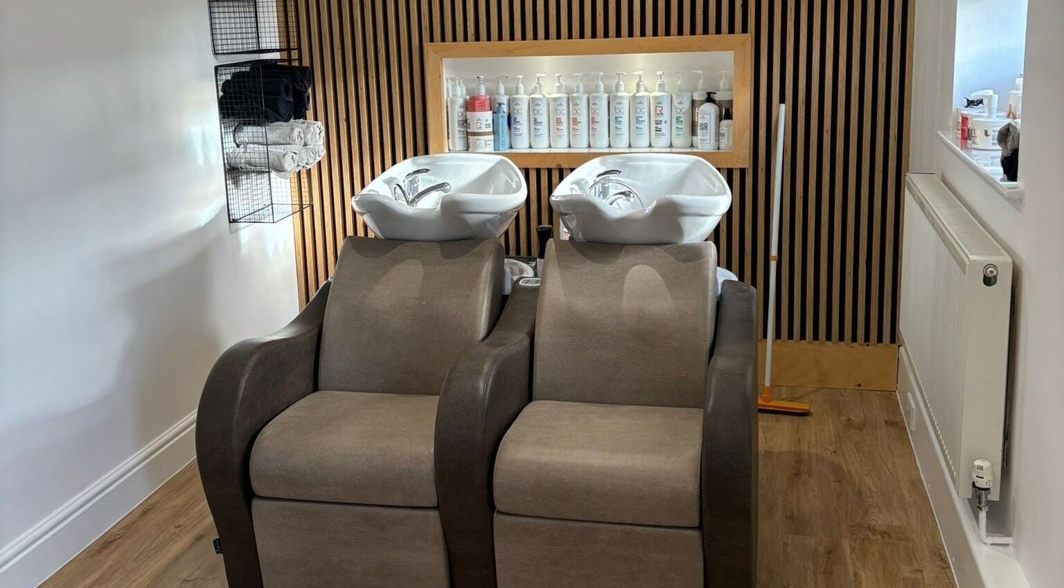 Elegant wash station at Chique Hair LTD in Greatworth, Hall, England, GB showcasing premium haircare setup.