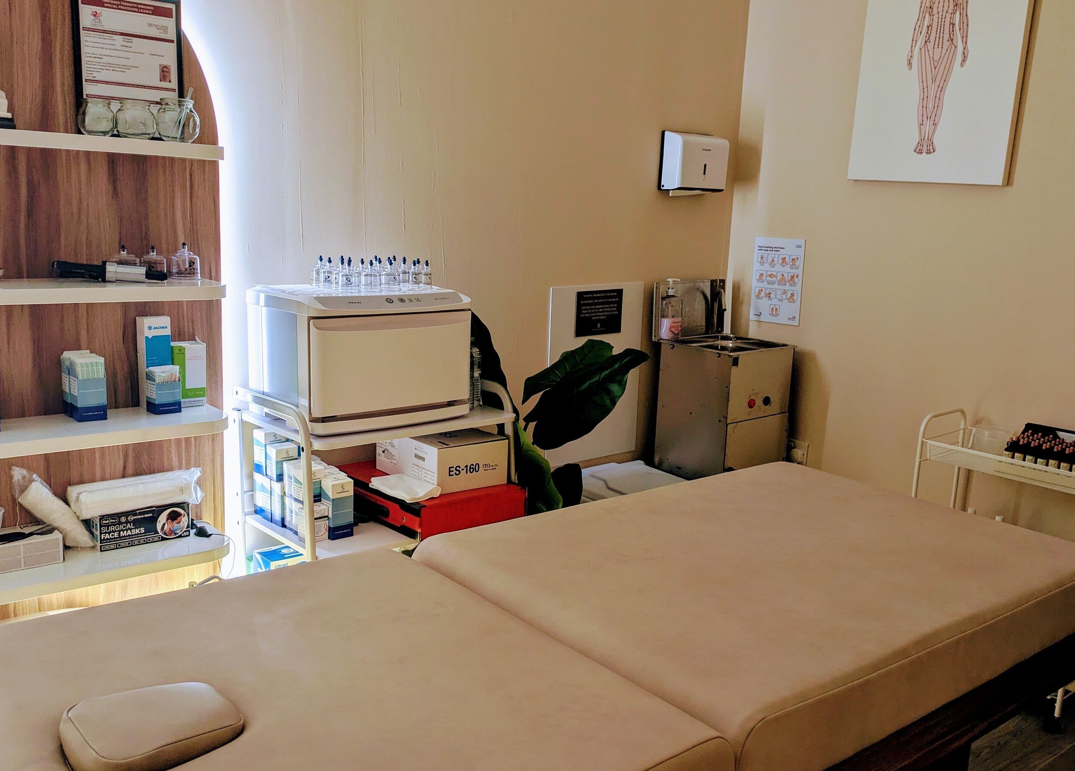 Therapy room at Holistic Therapies by Camille, Cardiff, Wales, GB, featuring treatment bed and shelves.
