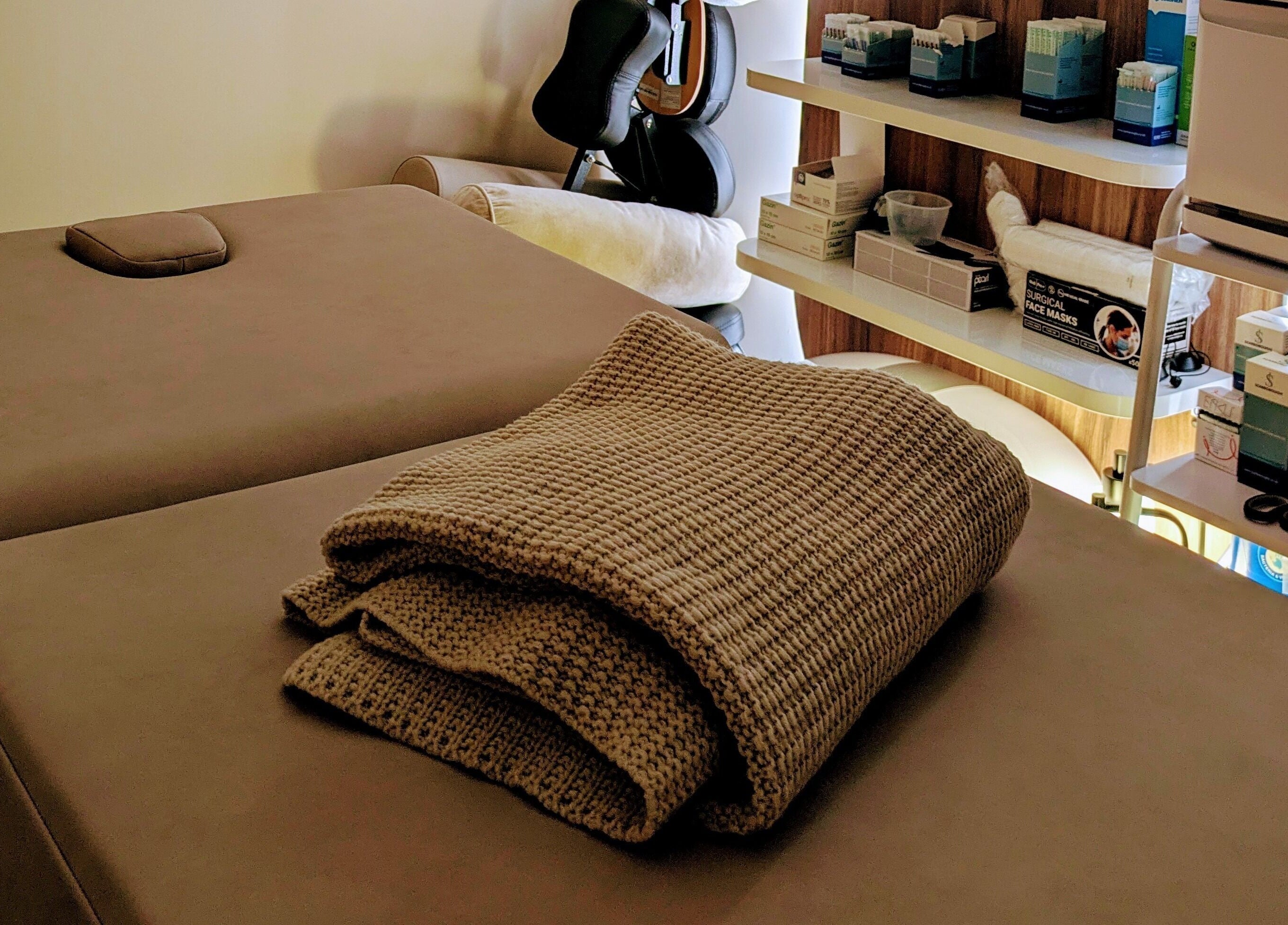 Massage table with towels at Holistic Therapies by Camille, Cardiff, Wales, GB, offers relaxing environment.