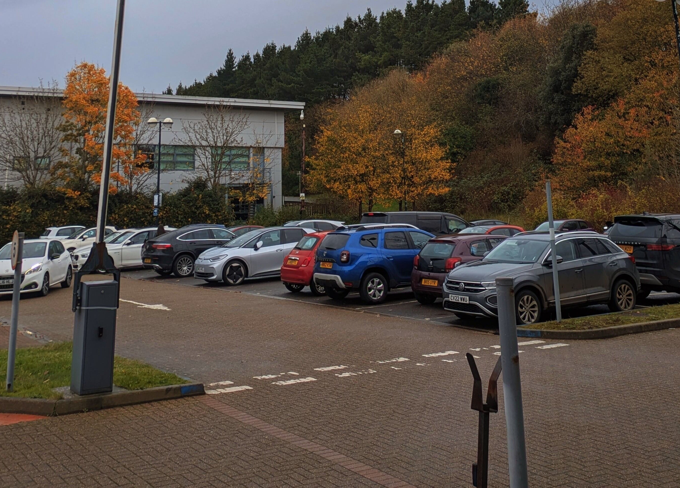 Spacious parking area at Holistic Therapies by Camille, amidst autumn trees in Cardiff, Wales, GB.