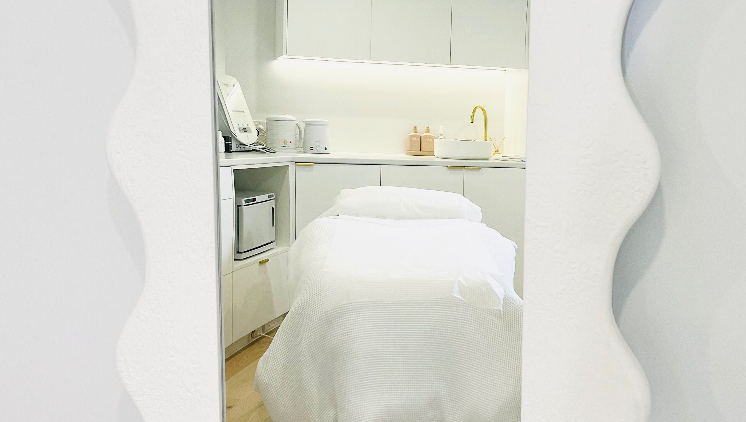Elegant treatment room at The Dermal Suite, Lower Plenty, Victoria, AU, featuring a stylish spa bed and modern decor.