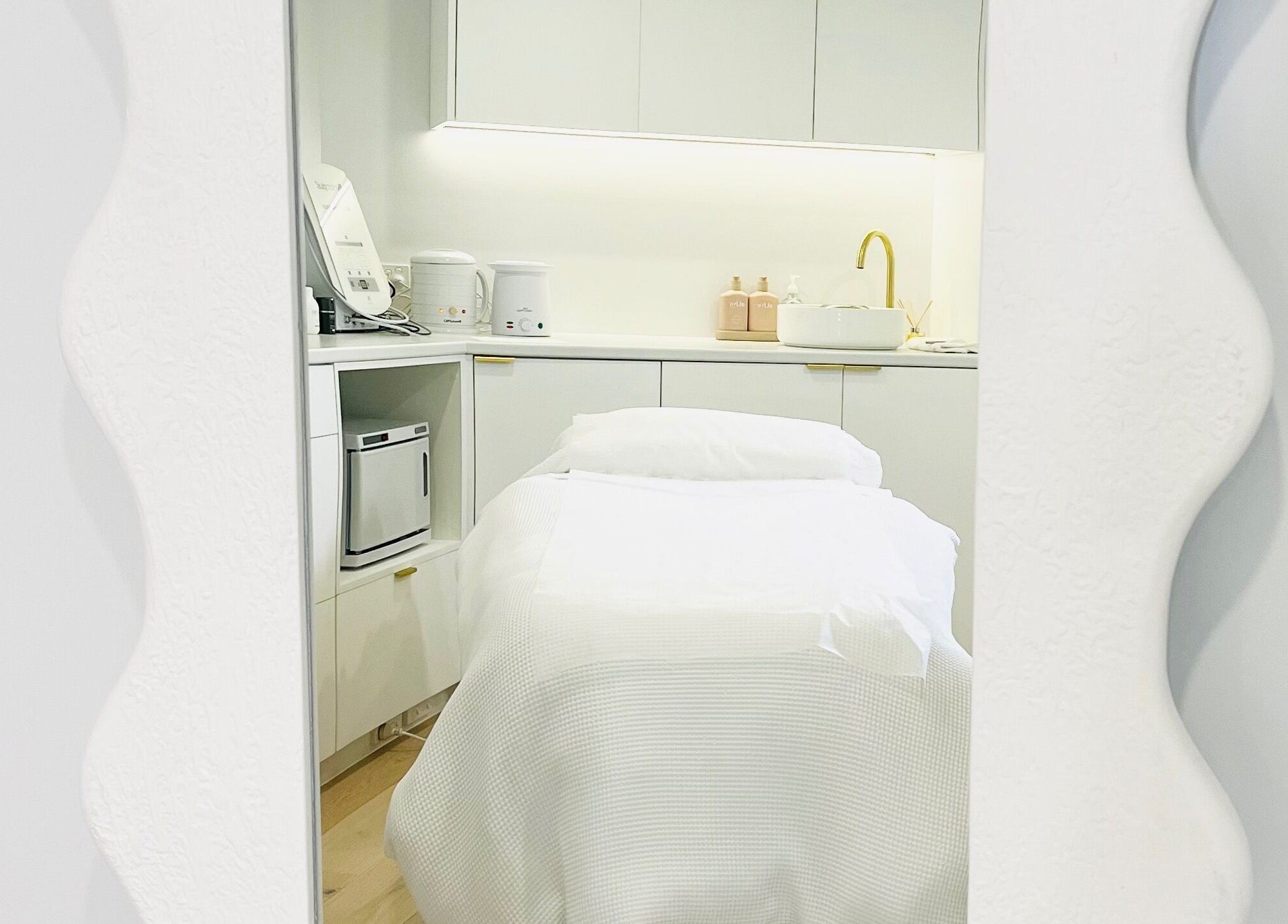 Elegant treatment room at The Dermal Suite, Lower Plenty, Victoria, AU, featuring a stylish spa bed and modern decor.