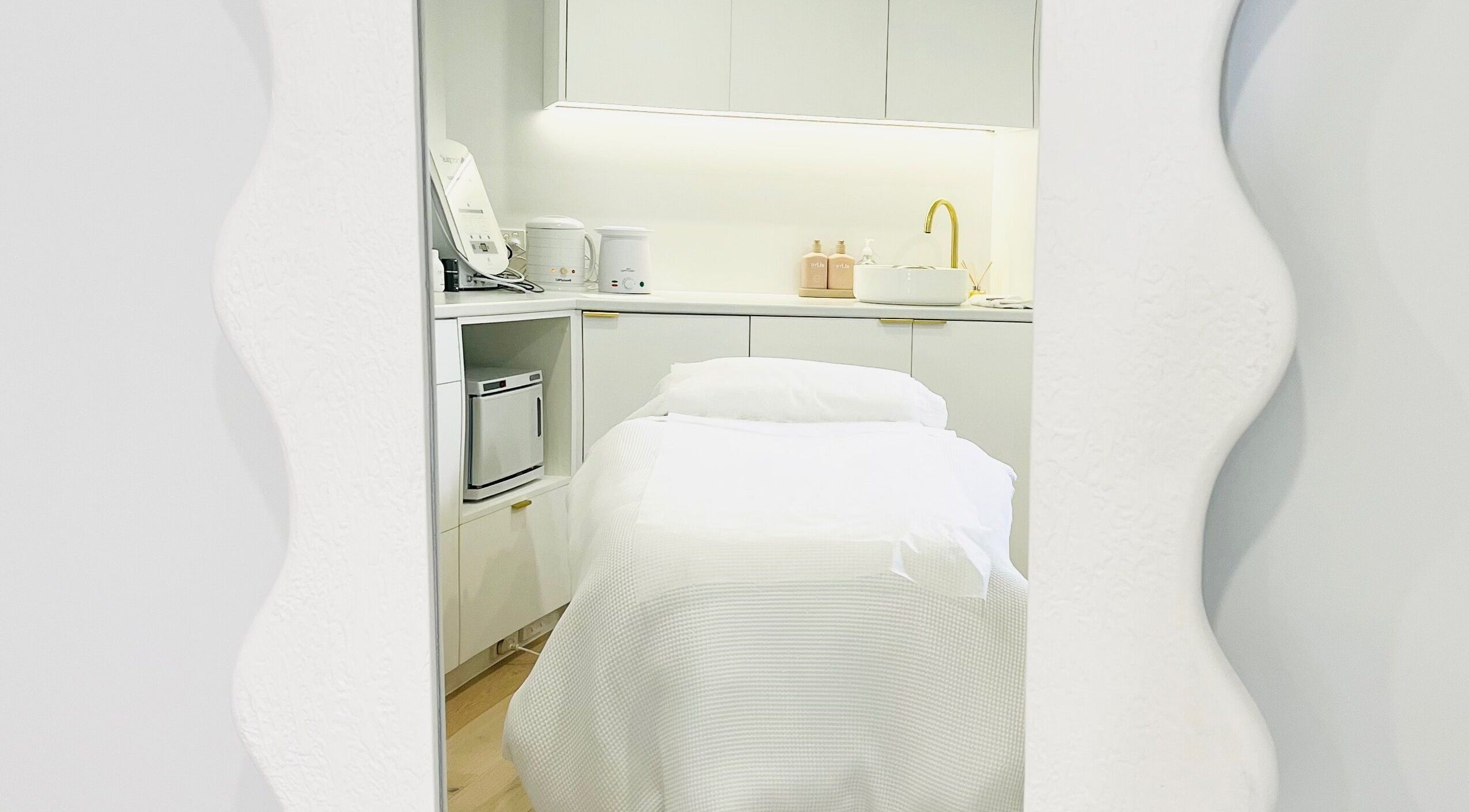 Elegant treatment room at The Dermal Suite, Lower Plenty, Victoria, AU, featuring a stylish spa bed and modern decor.