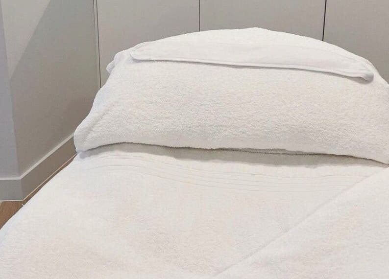 Luxurious spa bed at The Dermal Suite in Lower Plenty, Victoria, AU, offering ultimate relaxation.