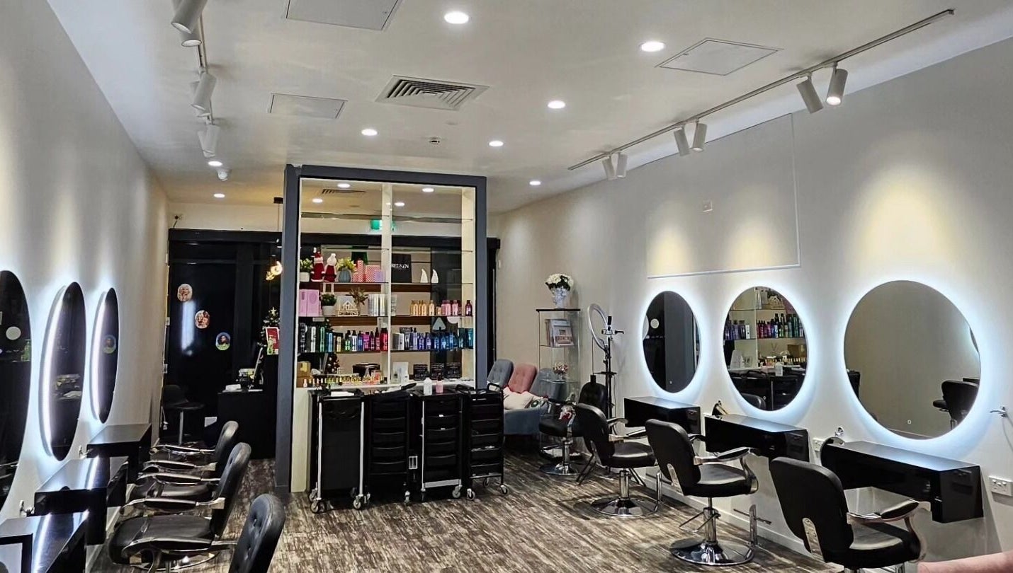Modern interior of Clipz Hair Design, Morningside, QLD, AU, featuring stylish mirrors and salon chairs.
