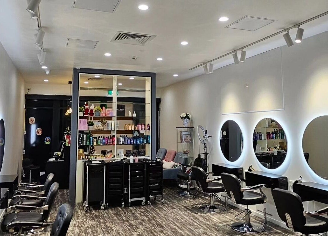 Modern interior of Clipz Hair Design, Morningside, QLD, AU, featuring stylish mirrors and salon chairs.