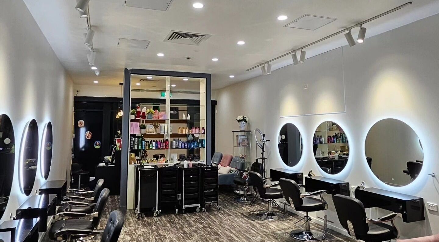 Modern interior of Clipz Hair Design, Morningside, QLD, AU, featuring stylish mirrors and salon chairs.