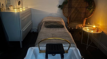 Tranquil massage room at Bodyworx Studios, St Austell, England, GB with ambient candles and cozy decor.