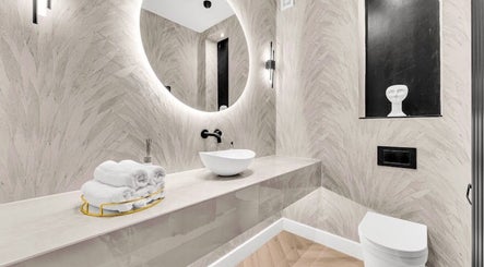 Elegant bathroom at Suburban Glow Wilmslow Lashes and Brows, Wilmslow, England, GB, featuring a sleek round mirror.