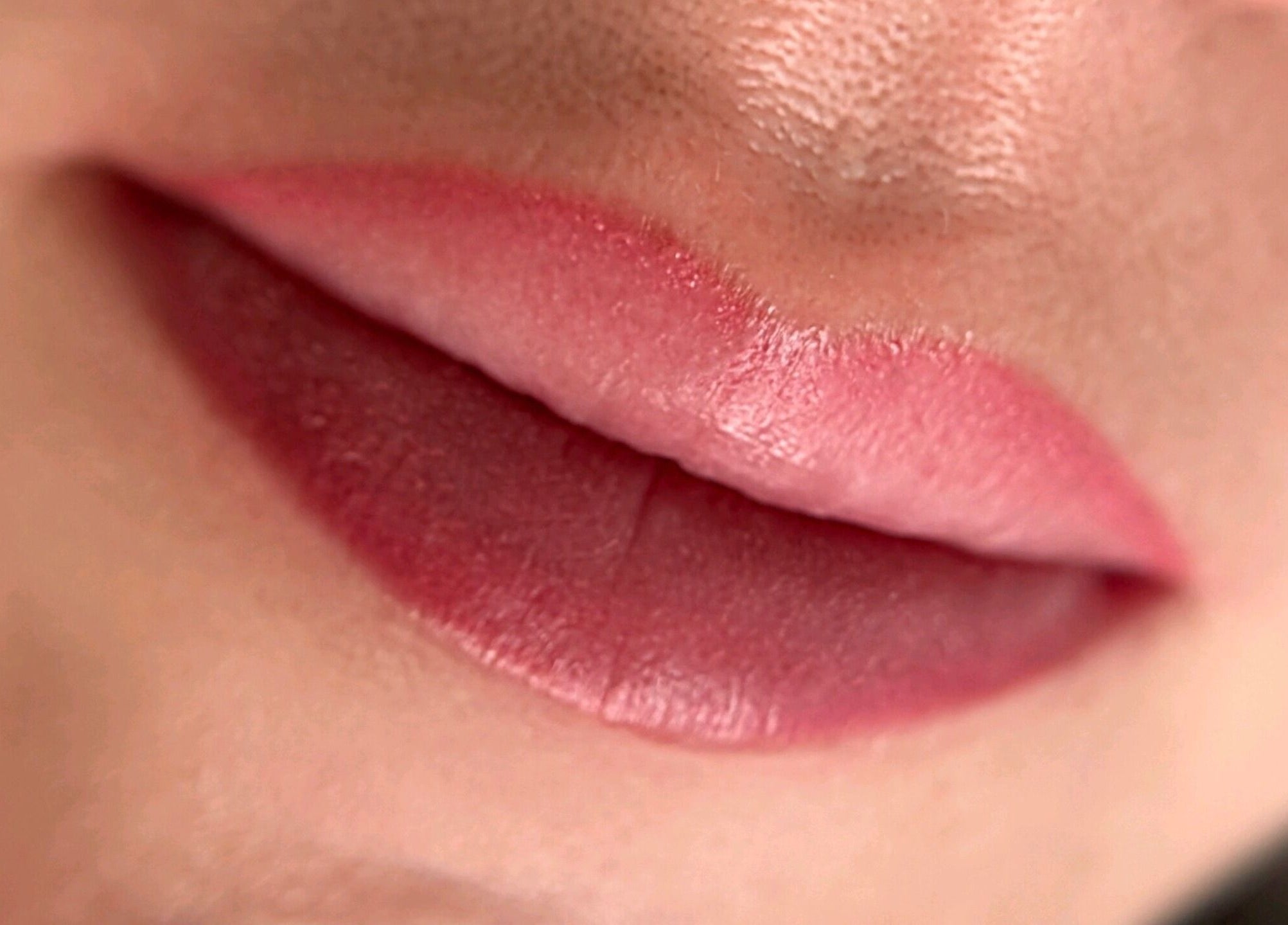 Close-up of lips with pink lipstick at Suburban Glow, Wilmslow, England, GB for beauty enhancement.