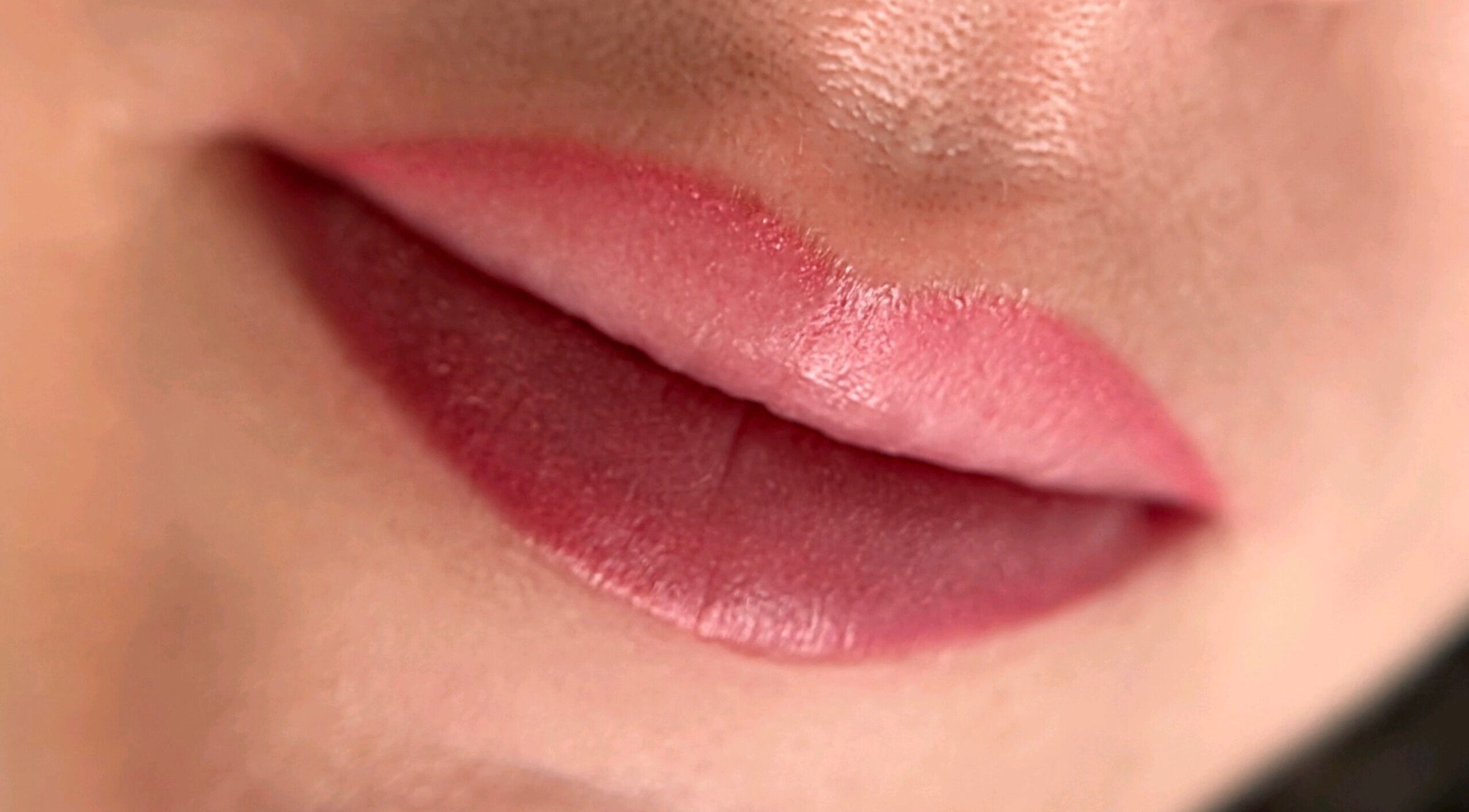Close-up of lips with pink lipstick at Suburban Glow, Wilmslow, England, GB for beauty enhancement.