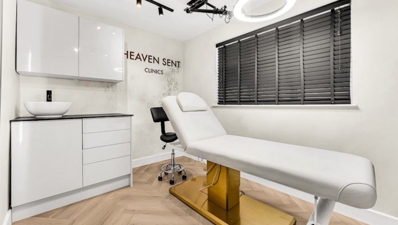 Well-designed treatment room at Suburban Glow, Wilmslow, England, GB, featuring modern decor and a comfortable bed.