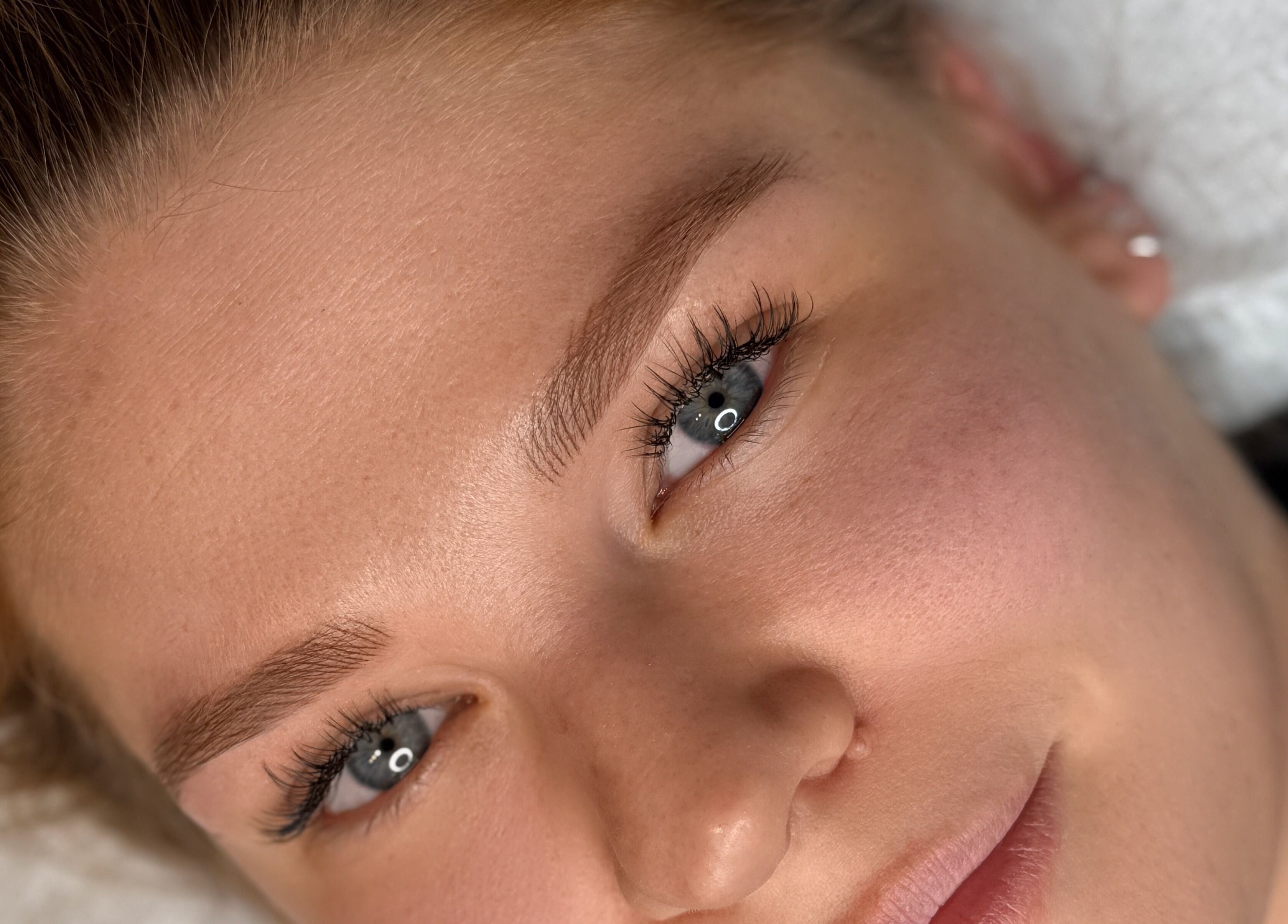 Close-up of client with glowing skin at Suburban Glow, Wilmslow, England, GB.