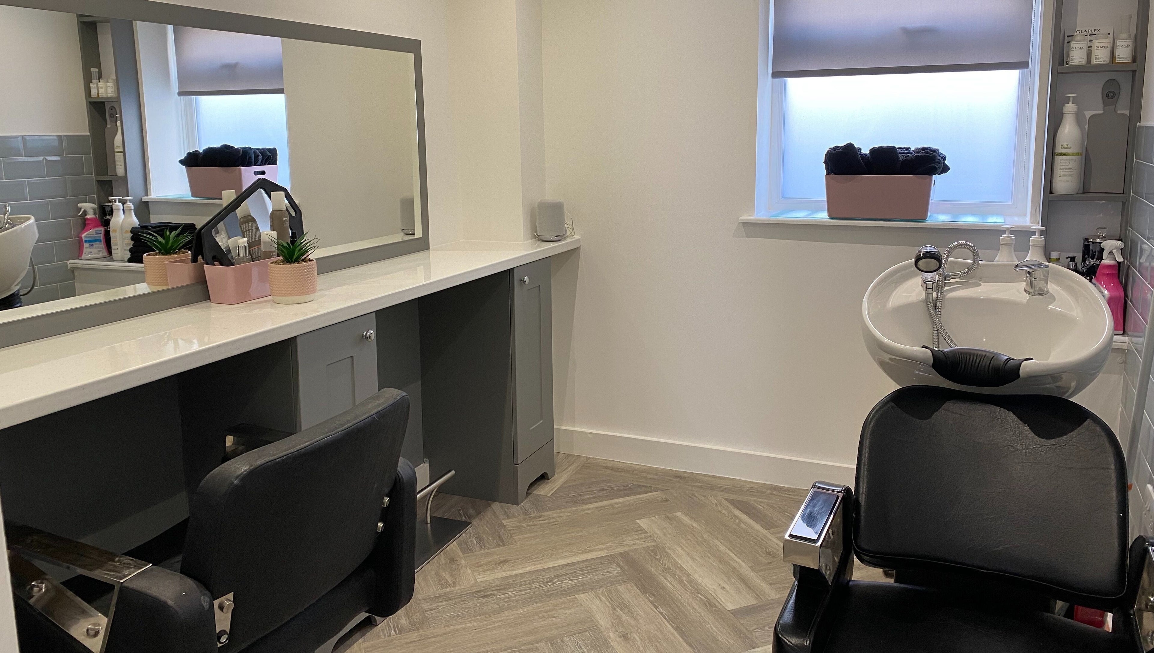 Modern beauty station at Polished House Of Beauty, Bury, England, GB featuring sleek salon chair and sink.