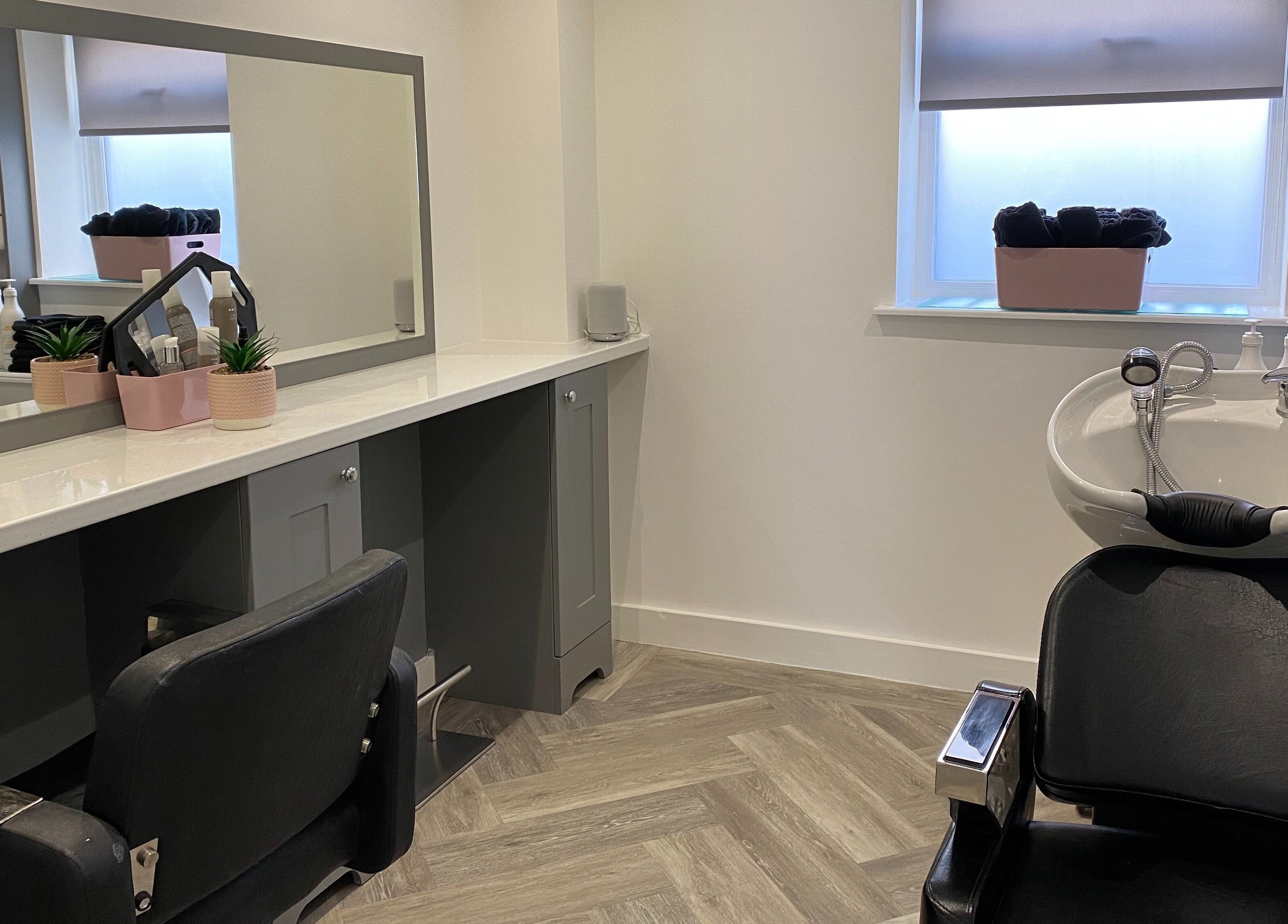 Modern beauty station at Polished House Of Beauty, Bury, England, GB featuring sleek salon chair and sink.