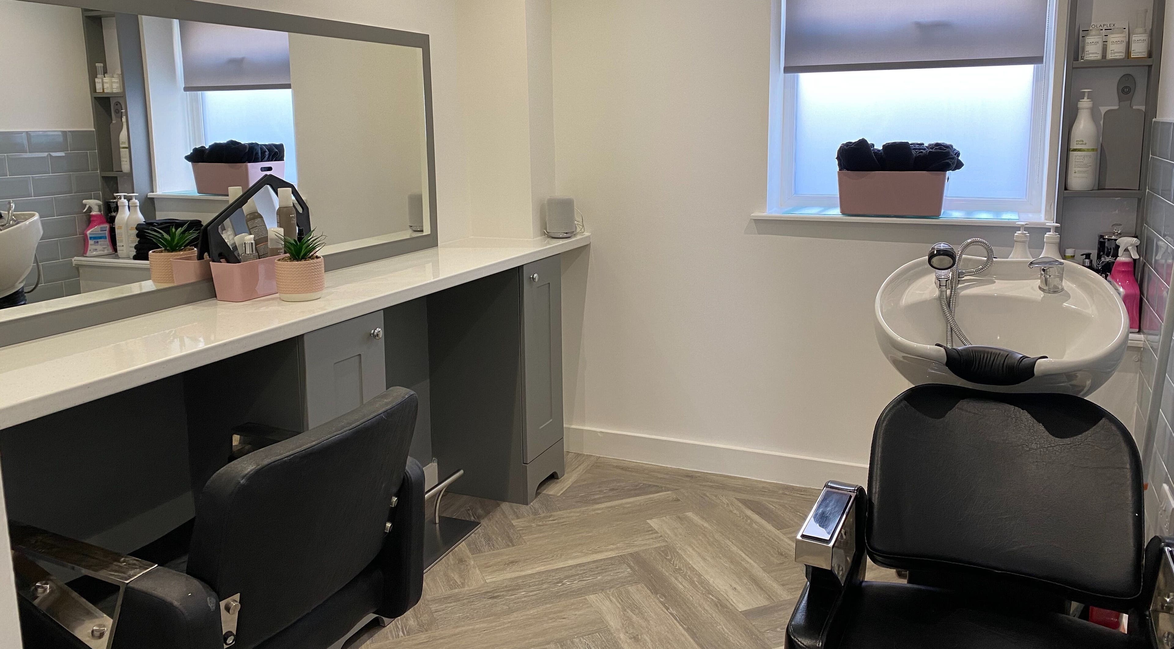 Modern beauty station at Polished House Of Beauty, Bury, England, GB featuring sleek salon chair and sink.