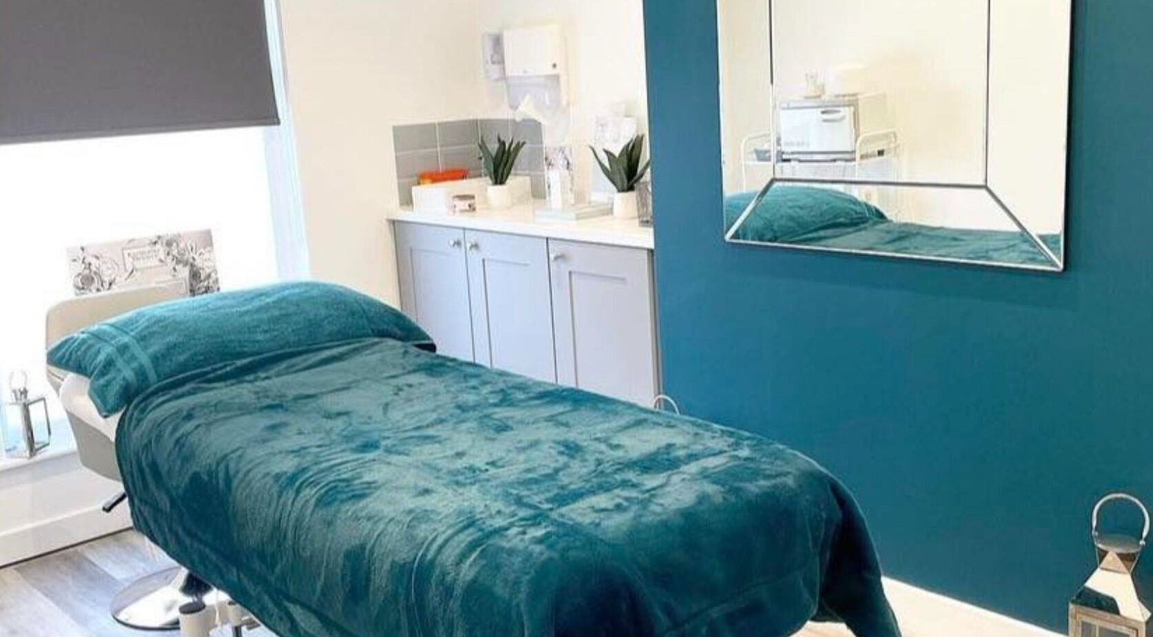 Polished House Of Beauty's serene treatment room with teal décor in Bury, England, GB.