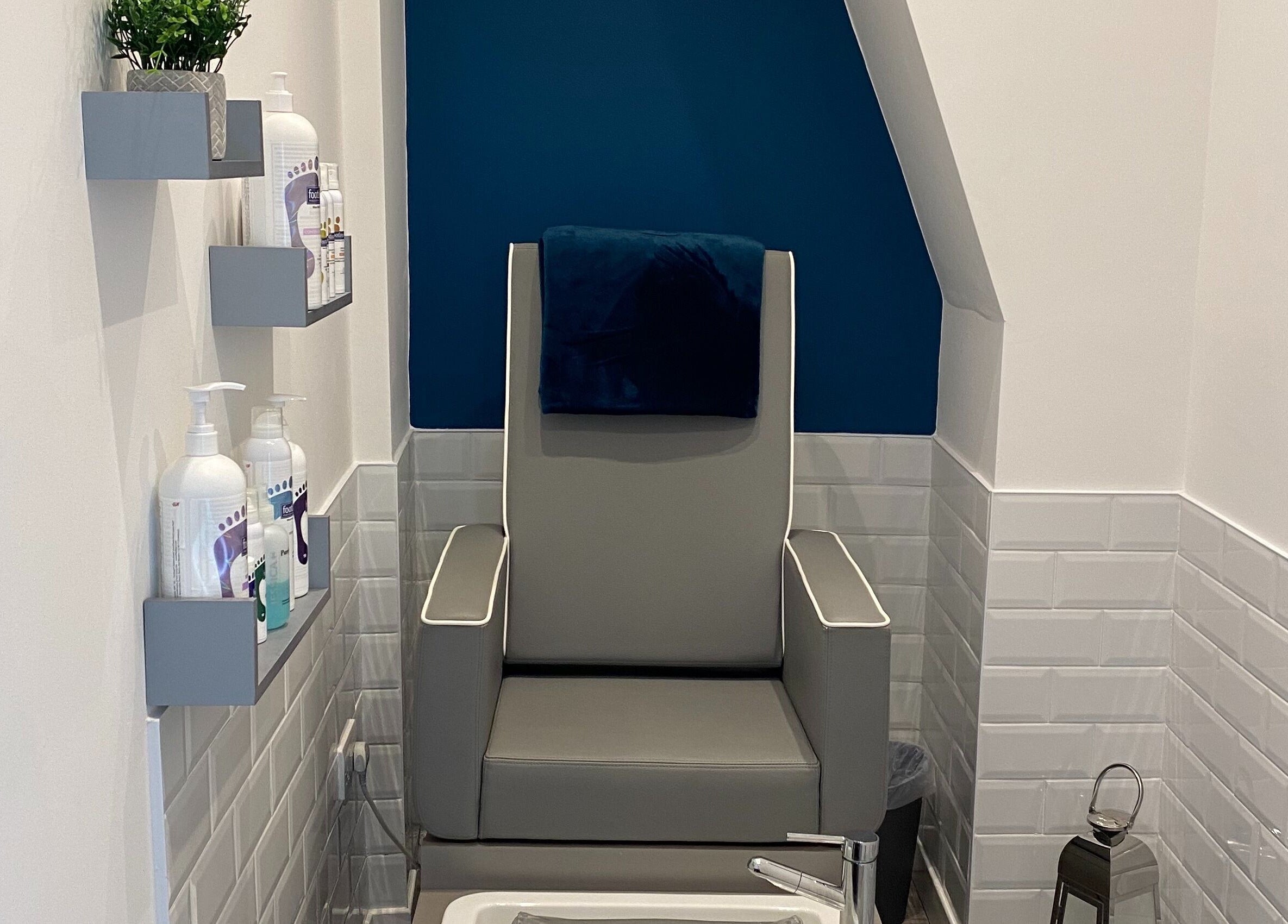 Pedicure chair in Polished House Of Beauty, Bury, England, GB, surrounded by sleek shelves and modern decor.