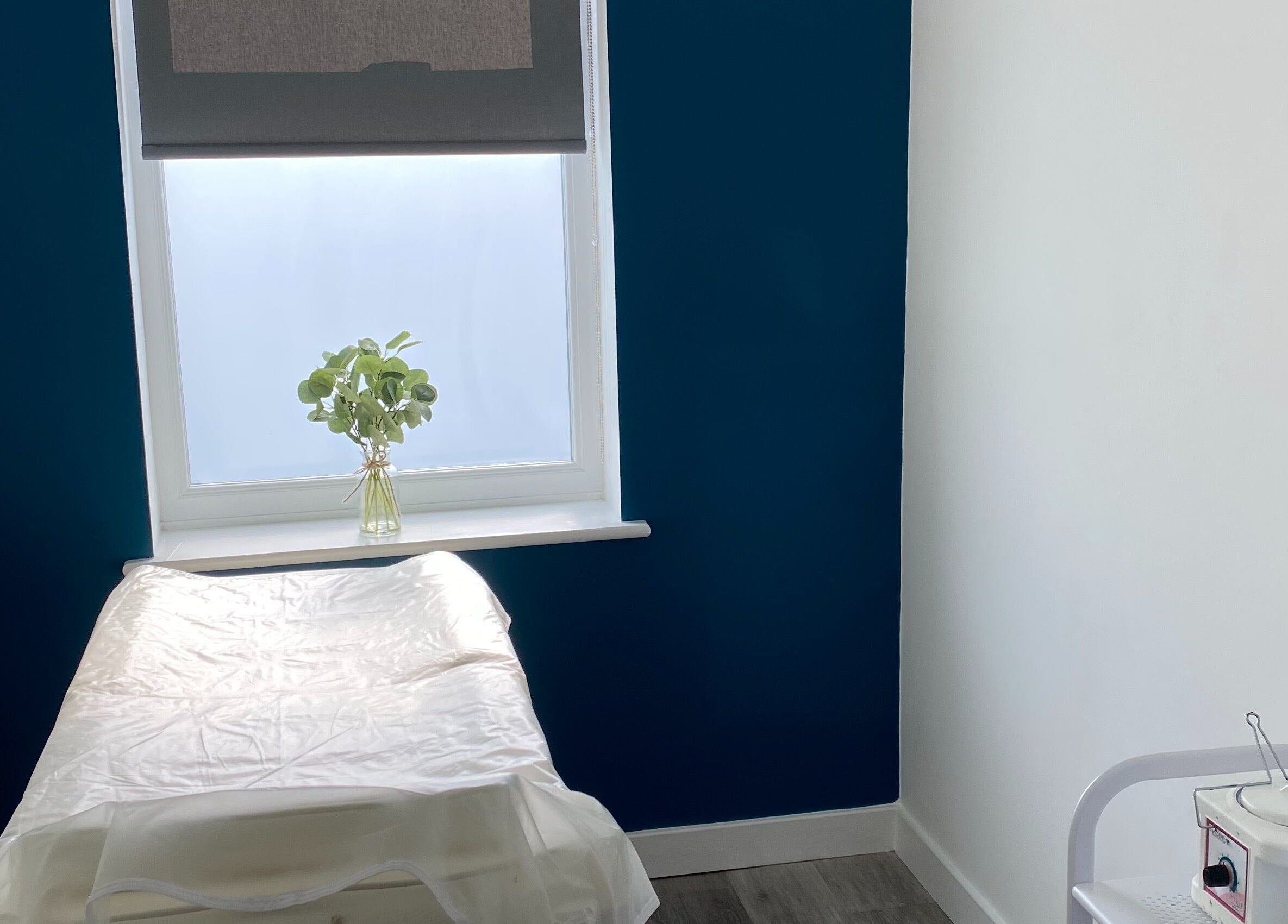 Bright treatment room at Polished House Of Beauty in Bury, England, GB, featuring a massage table and soft lighting.