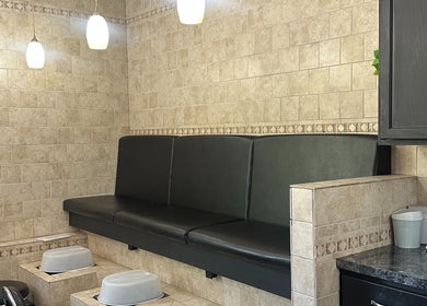 Pedicure section at The Studio at the Jackson Area Career Center in Jackson, Michigan, US, featuring black seating.