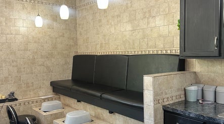 Pedicure section at The Studio at the Jackson Area Career Center in Jackson, Michigan, US, featuring black seating.