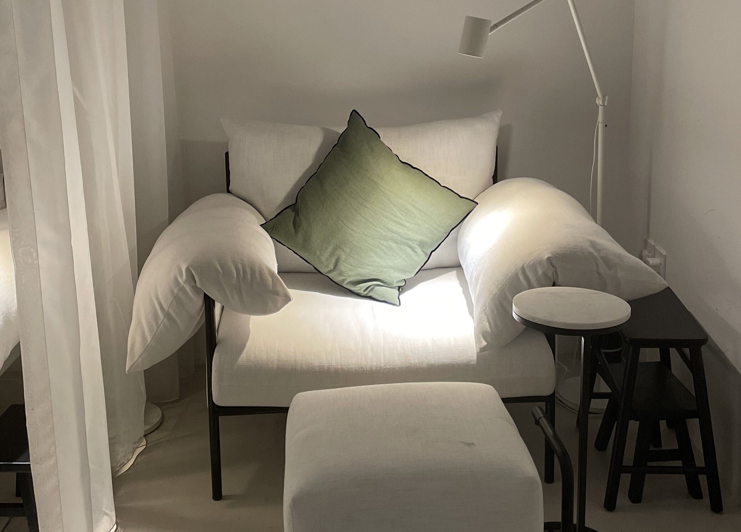 Comfortable seating area at De Oliva Spa, Riyadh, SA, with plush cushions and minimalist decor.