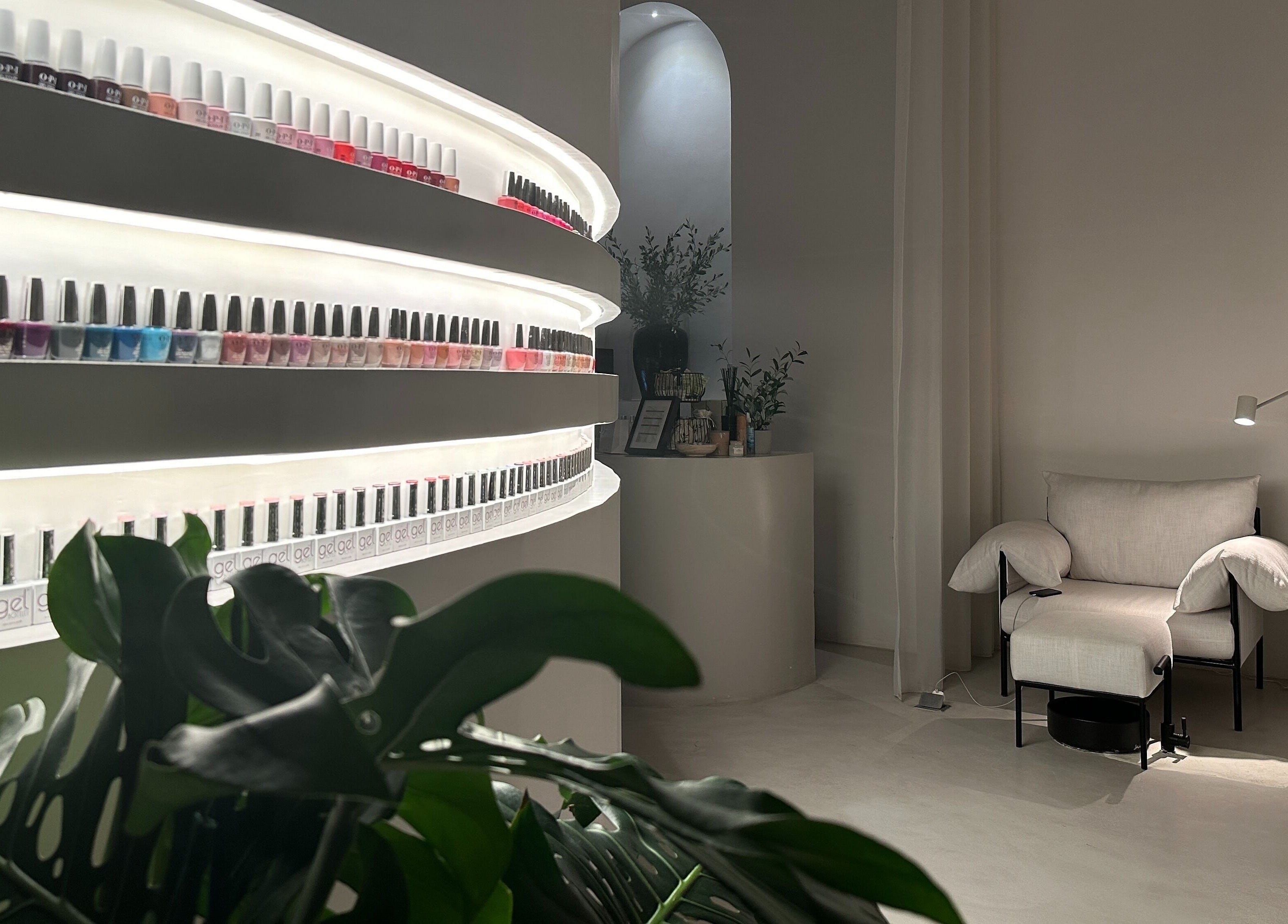 Elegant nail polish display and cozy seating at De Oliva Spa, Riyadh, SA, enhancing the tranquil ambiance.