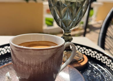 Cup of coffee with sunlight at Modo Hair Salon, Peguera, Illes Balears, ES, enhancing relaxation and beauty.