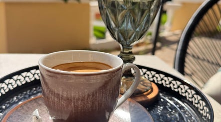 Cup of coffee with sunlight at Modo Hair Salon, Peguera, Illes Balears, ES, enhancing relaxation and beauty.
