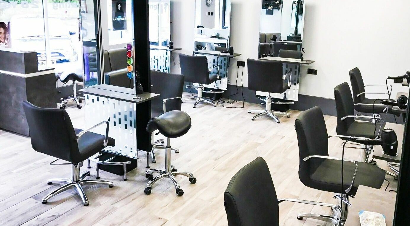 Spacious interior of The Wel-don Hair Salon Ltd in Rotherham, England, GB with modern styling stations.