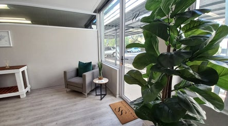 Inviting interior of Skin Salvation by Monique in Windhoek, Khomas Region, NA with cozy seating and vibrant greenery.