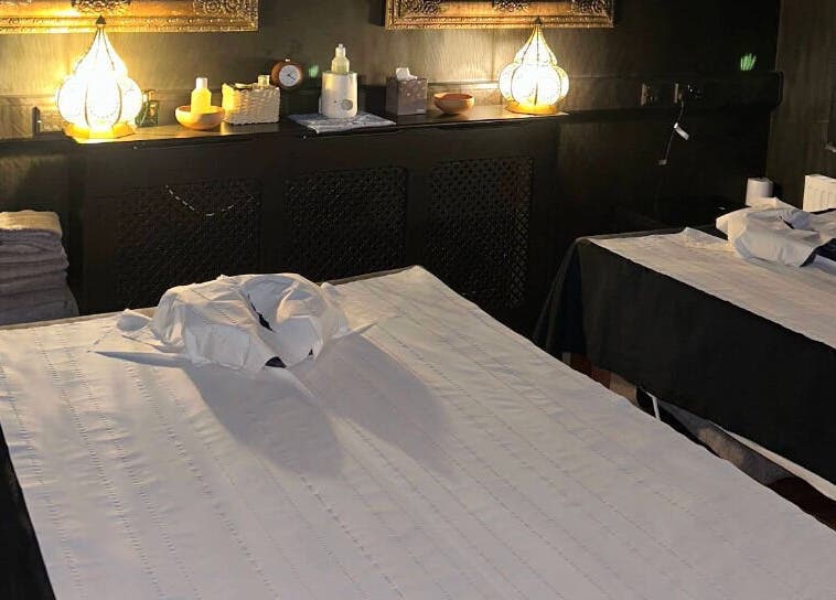 Tranquil massage room at The Mansion Spa in Birmingham, England, GB with twin tables and ambient lighting.