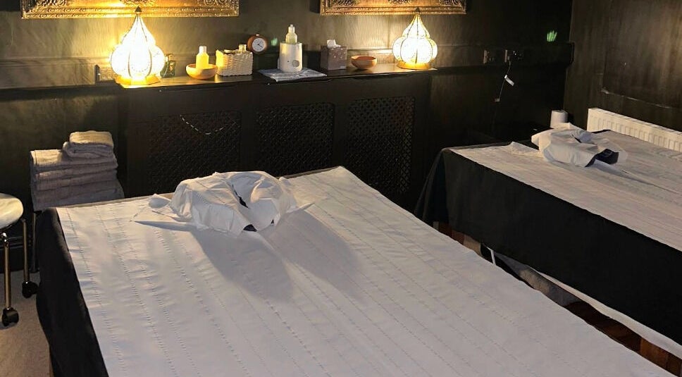 Tranquil massage room at The Mansion Spa in Birmingham, England, GB with twin tables and ambient lighting.