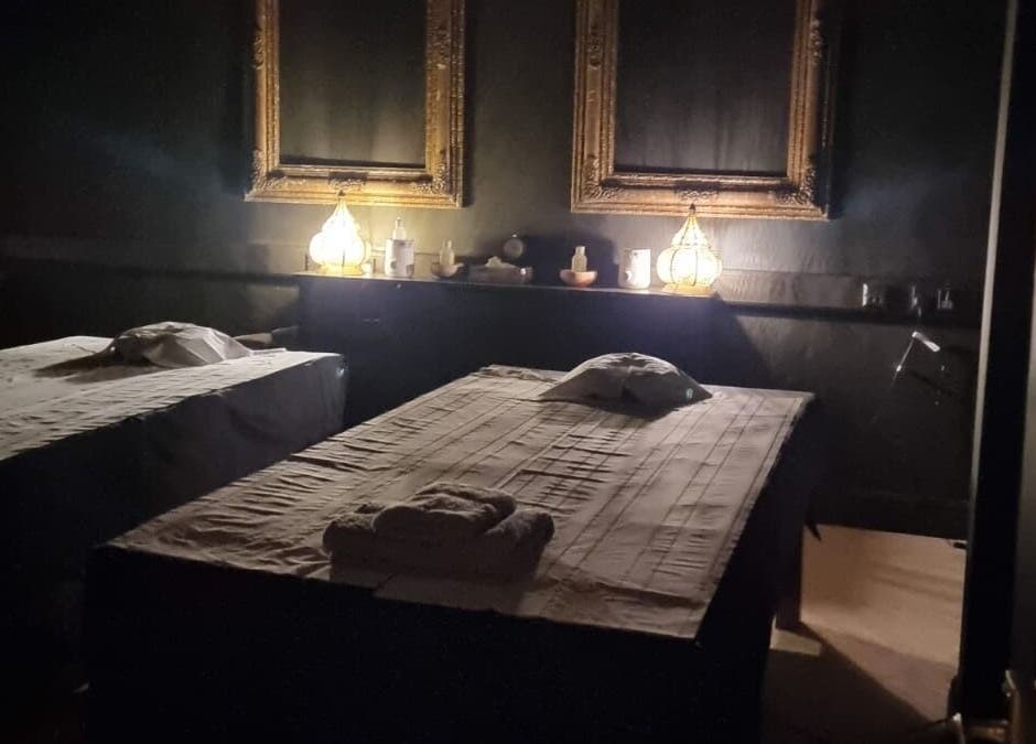 Relaxing massage room at The Mansion Spa, Birmingham, England, GB with ambient lighting and cozy decor.