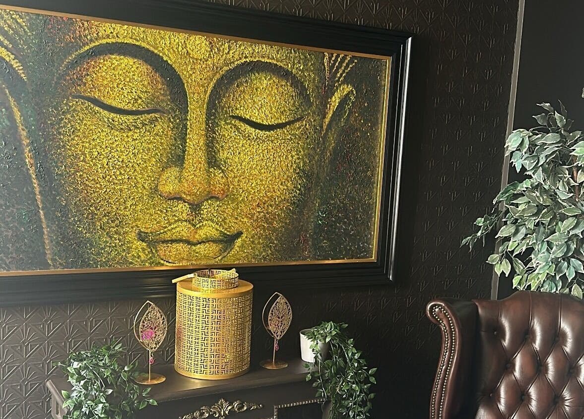 Golden Buddha art and leather chair at The Mansion Spa, Birmingham, England, GB.