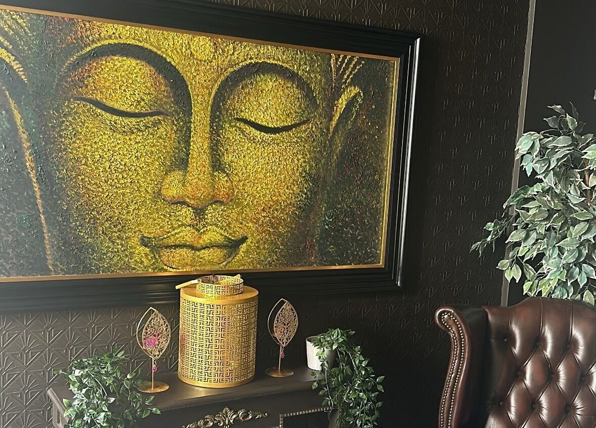 Golden Buddha art and leather chair at The Mansion Spa, Birmingham, England, GB.