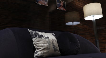 Cozy seating area with cushion and lamp at Mahogany Nail Spa, Riyadh, Riyadh Province, SA.